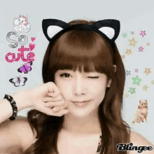 a woman wearing a cat ear headband is making a face .