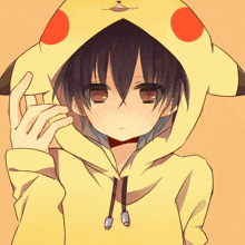 a boy wearing a pikachu hoodie with red dots on it