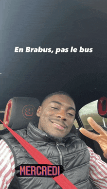 a man sitting in a car with the words en brabus pas le bus underneath him