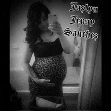 a black and white photo of a pregnant woman taking a selfie with the name jaslyn jenay sanchez