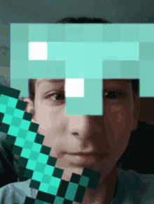 a person 's face is covered by a pixelated diamond sword