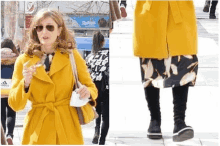 a woman wearing a yellow coat and sunglasses is walking down a street .