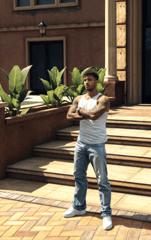 a man in a white tank top and jeans stands on a set of stairs