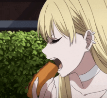 a girl with blonde hair is eating a sandwich