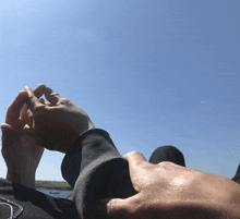 a couple holding hands against a blue sky