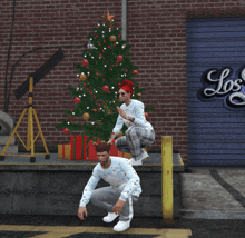 a couple squatting in front of a christmas tree in front of a los garage