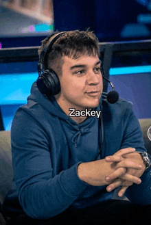 a man wearing headphones and a microphone with the name zackey written on the bottom