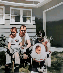 a family posing for a picture in front of their house