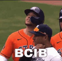 a group of baseball players are standing on a field and one of them is wearing an orange jersey with the word bcib on it