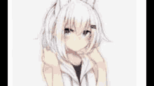 a white haired anime girl with cat ears and blue eyes is sitting down .