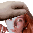 a woman with red hair is being touched by a hand .