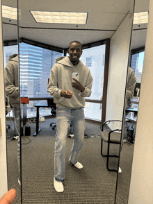 a man is taking a selfie in front of a mirror