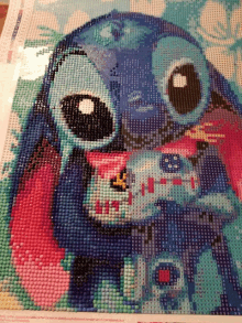 a diamond painting of a stitch holding a baby