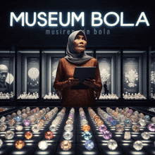 a woman stands in front of a display of diamonds in a museum called museum bola