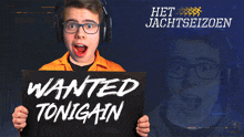 a man wearing headphones holds a sign that says wanted tonigain