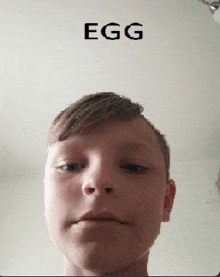 a close up of a boy 's face with the word egg above it