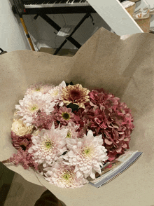 a bouquet of pink and white flowers with a card that says ' i love you ' on it