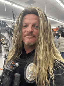 a man wearing a wig and a badge that says emergency security