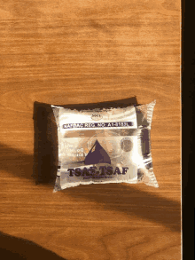 a package of tsaf water is sitting on a wooden table