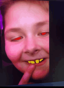 a child with red eyes and yellow teeth