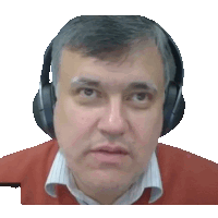 a man wearing headphones and a red sweater looks at the camera