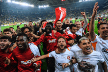 a group of soccer players wearing sixt shirts celebrate