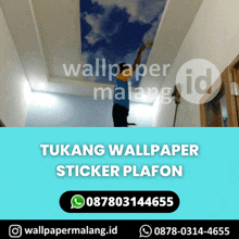 a man is painting a picture of a cloudy sky on the ceiling of a room