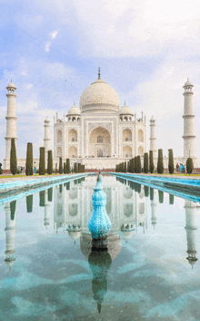 a large white building is reflected in a pond