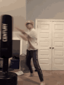 a man is hitting a century punching bag in a bedroom