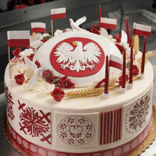 a cake with a white eagle on top and red and white flags around it