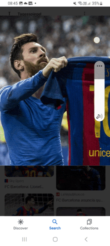 a phone screen shows a soccer player holding up a jersey that says unicef