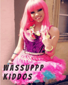 a woman wearing a pink wig and a pink dress with the words wassuppp kiddos on the bottom