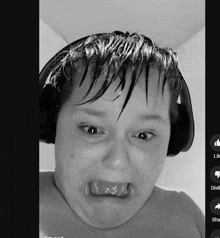 a black and white photo of a boy with headphones on making a funny face