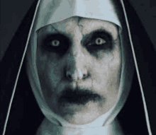 a close up of a nun 's face with glowing eyes .