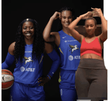 two female basketball players wearing at & t jerseys pose for a photo