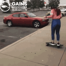 a woman is riding a skateboard on a sidewalk in front of a red car that says gains associates on it