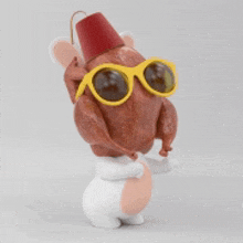 a figurine of a turkey wearing sunglasses and a red top hat