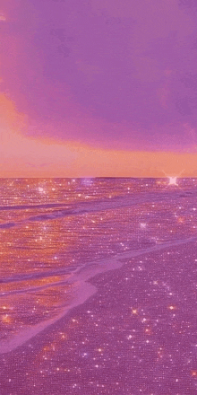 a purple and orange sunset over a glittery beach with a purple sky .