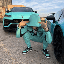 a man squatting in front of a car that has a license plate that says lnv