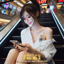 a woman wearing glasses is sitting on an escalator looking at her cell phone