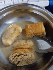 a spoon is in a bowl of food with a keyboard in the background with the ctrl key visible