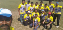 a man wearing a hat that says harmony poses for a photo with his teammates