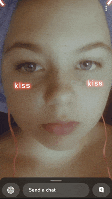 a close up of a woman 's face with kiss written on her face