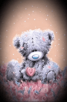 a teddy bear is sitting on a pile of flowers with a heart in its paws .