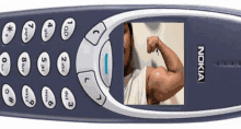 a nokia phone with a picture of a man flexing his muscles on the screen