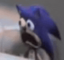 a close up of a sonic the hedgehog stuffed animal with a surprised look on his face .