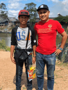 a man wearing a red shirt that says russia is standing next to another man