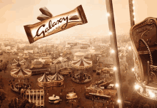 a galaxy chocolate bar is sitting on top of a carnival ride