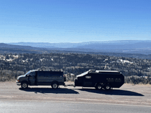 a van is pulling a trailer with a camper on it