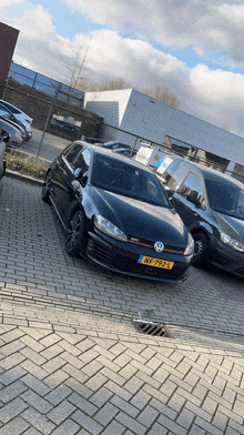 a black volkswagen with a license plate that says nf-7922 is parked in a parking lot